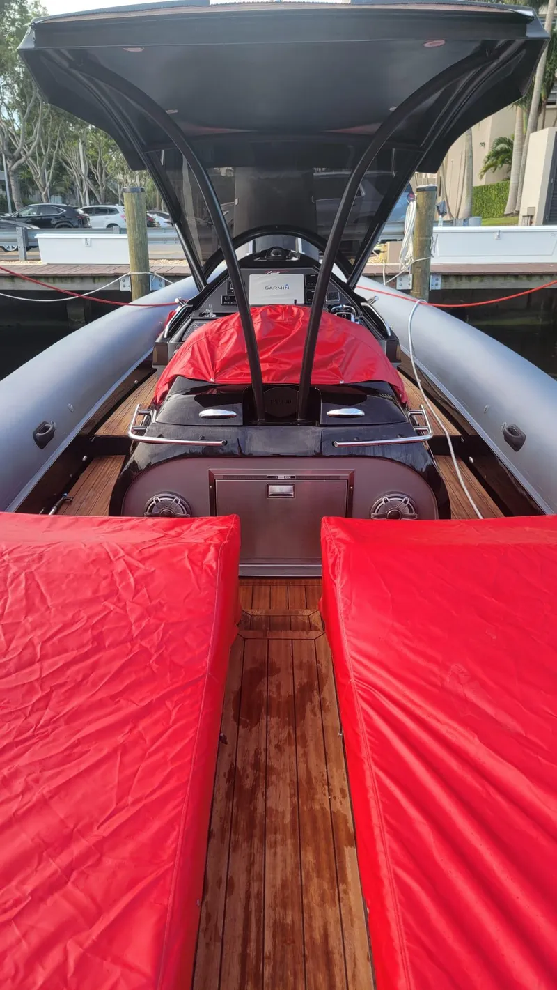 Slide: The Image of 2021 Panamera Yacht PY 100 with red covers and sleek design at a marina. - 3