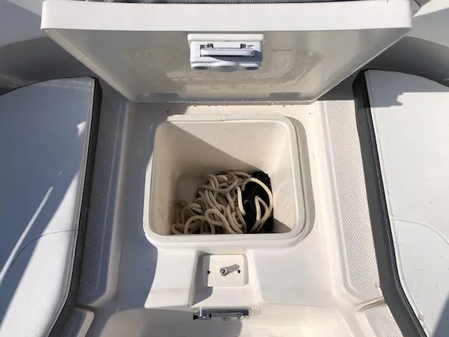 Slide: The Image of 2022 Robalo R242 Center Console boat storage compartment with rope. - 11