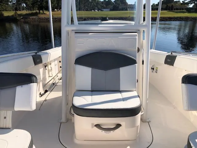Slide: The Image of 2022 Robalo R242 Center Console boat interior with seating and water view. - 13