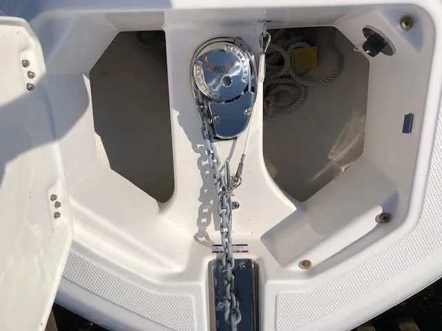 Slide: The Image of 2022 Robalo R242 Center Console anchor compartment with chain and rope storage. - 14