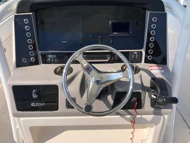 Slide: The Image of 2022 Robalo R242 Center Console dashboard with steering wheel and controls. - 19