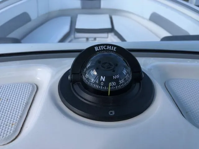 Slide: The Image of Ritchie compass on 2022 Robalo R242 Center Console boat dashboard. - 22