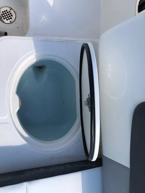 Slide: The Image of 2022 Robalo R242 Center Console livewell with open lid. - 26