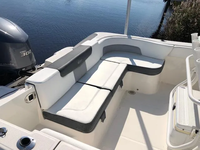 Slide: The Image of 2022 Robalo R242 Center Console boat with cushioned seating and powerful engine. - 4