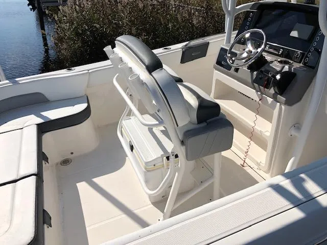 Slide: The Image of 2022 Robalo R242 Center Console boat interior with helm and seating. - 5