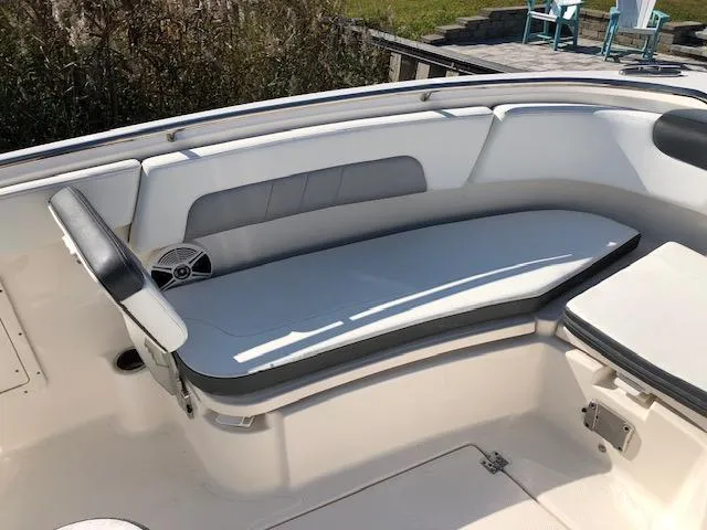 Slide: The Image of 2022 Robalo R242 Center Console boat interior with cushioned seating. - 9