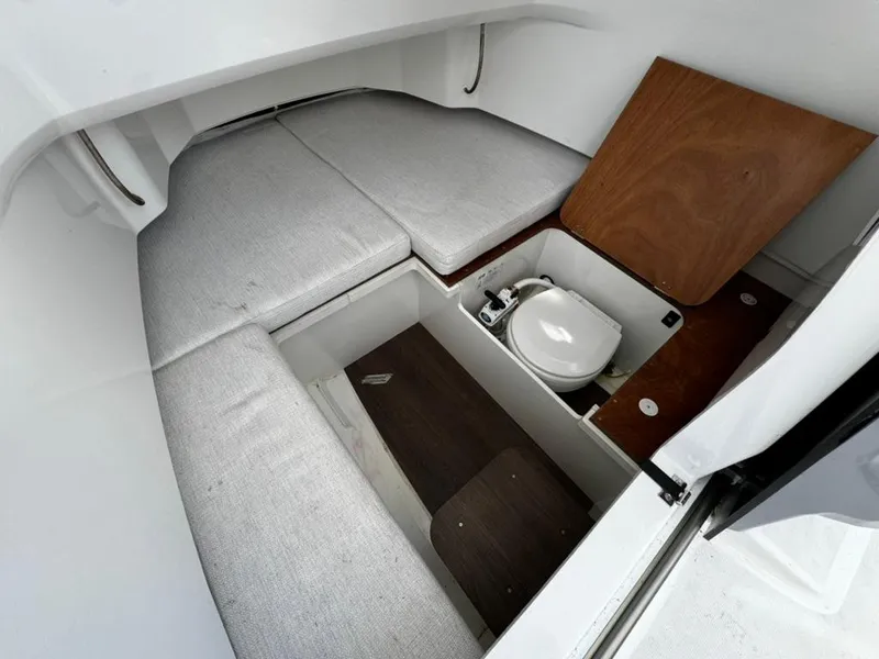 Slide: The Image of 2023 Jeanneau Leader 7.5 CC Series 3 cabin interior with seating and compact toilet. - 10