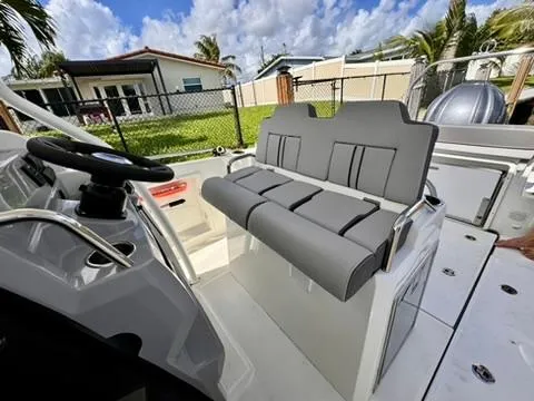 Slide: The Image of 2023 Jeanneau Leader 7.5 CC Series 3 boat interior with gray seating and steering wheel. - 12