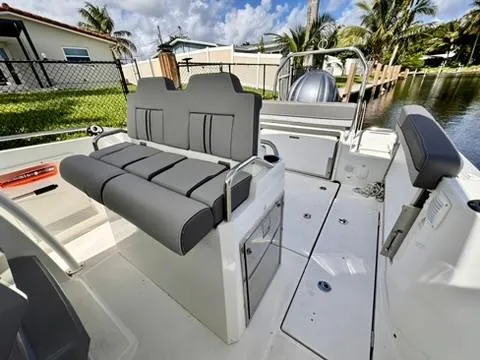 Slide: The Image of 2023 Jeanneau Leader 7.5 CC Series 3 boat interior with gray seating and canal view. - 13