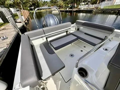Slide: The Image of 2023 Jeanneau Leader 7.5 CC Series 3 boat interior with gray seating by a canal. - 14