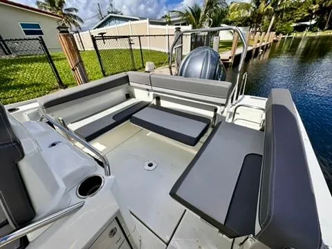 Slide: The Image of 2023 Jeanneau Leader 7.5 CC Series 3 boat interior with seating, docked by water. - 16