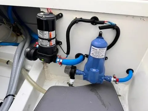 Slide: The Image of 2023 Jeanneau Leader 7.5 CC Series 3 boat engine compartment with pumps and hoses. - 21