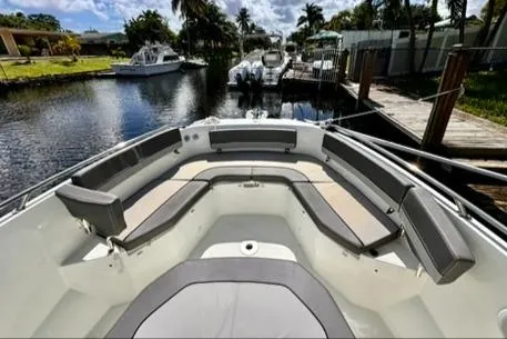 Slide: The Image of 2023 Jeanneau Leader 7.5 CC Series 3 boat with spacious seating in a scenic marina. - 25