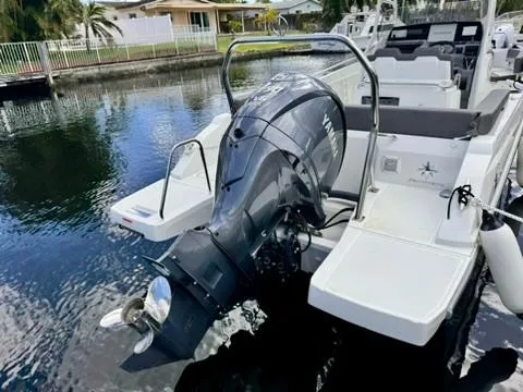 Slide: The Image of 2023 Jeanneau Leader 7.5 CC Series 3 boat with outboard motor on water. - 6