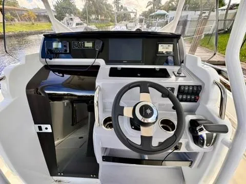 Slide: The Image of Cockpit of 2023 Jeanneau Leader 7.5 CC Series 3 boat with modern controls and steering wheel. - 9