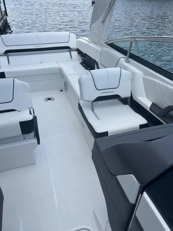 Slide: The Image of 2025 Formula 290 Bowrider interior with sleek white seating and open deck design. - 12