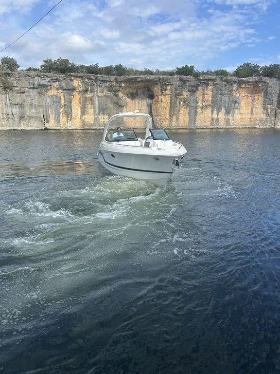 Slide: The Image of 2025 Formula 290 Bowrider cruising on a scenic lake with rocky cliffs. - 3
