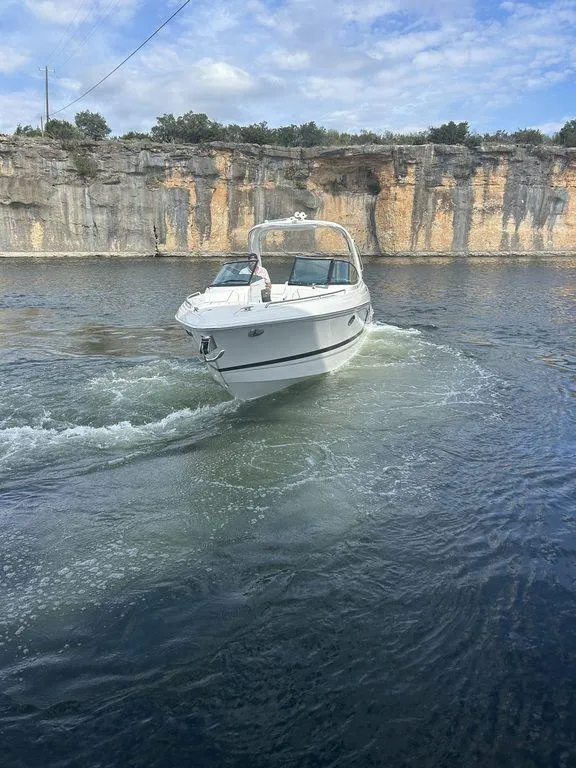 Slide: The Image of 2025 Formula 290 Bowrider cruising on a scenic lake with rocky cliffs. - 4