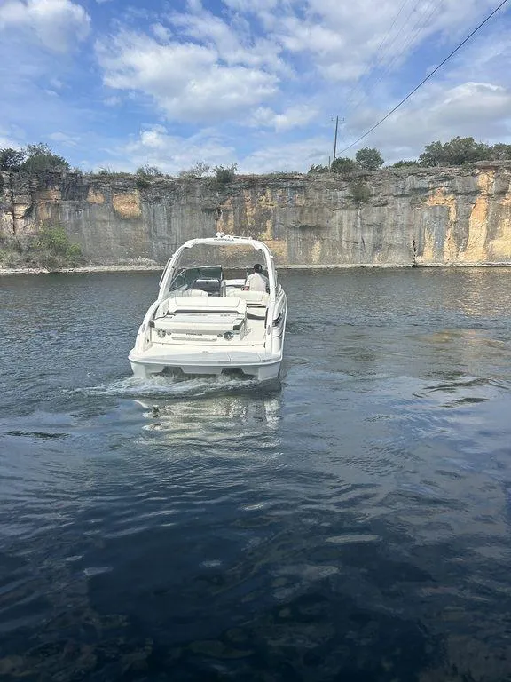 Slide: The Image of 2025 Formula 290 Bowrider on serene lake with rocky cliffs in background. - 8