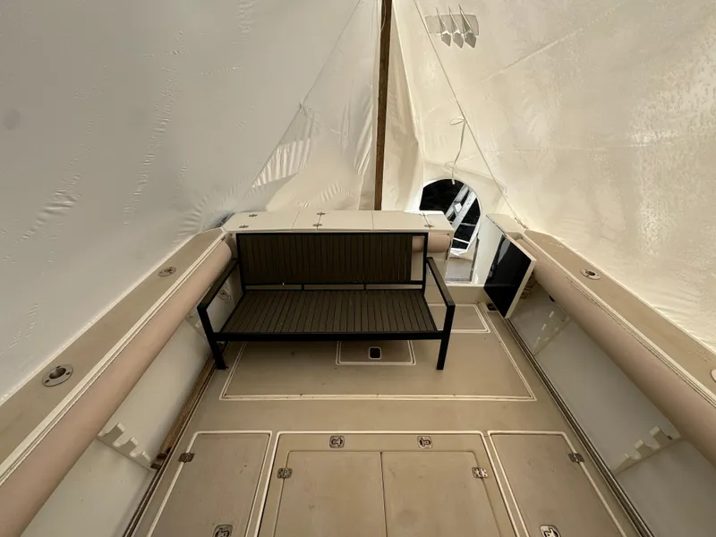 Slide: The Image of 2003 Albin 28 TE Flush Deck interior with bench seating and beige flooring. - 10