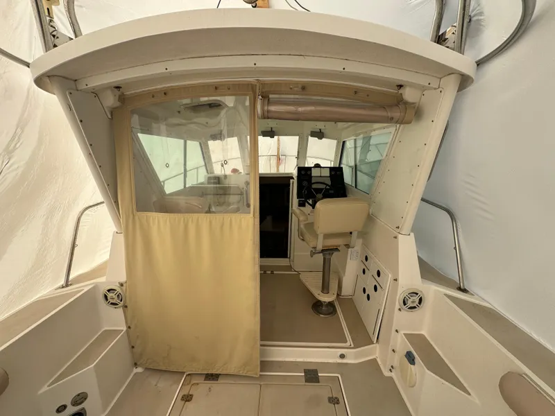 Slide: The Image of 2003 Albin 28 TE Flush Deck boat interior with helm and seating area. - 11