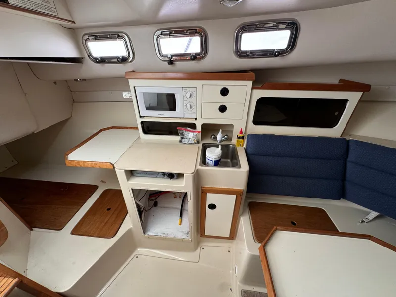 Slide: The Image of 2003 Albin 28 TE Flush Deck interior with kitchenette and seating area. - 20