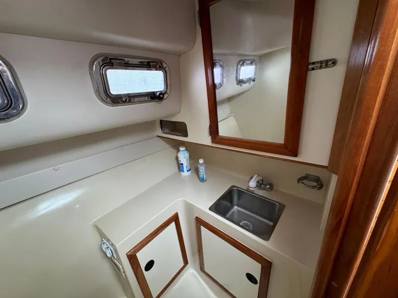 Slide: The Image of 2003 Albin 28 TE Flush Deck boat interior with sink and mirror. - 24