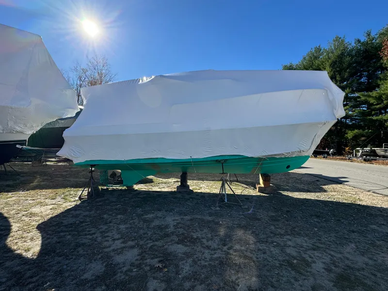 Slide: The Image of 2003 Albin 28 TE Flush Deck boat covered in white tarp, outdoors under bright sunlight. - 27