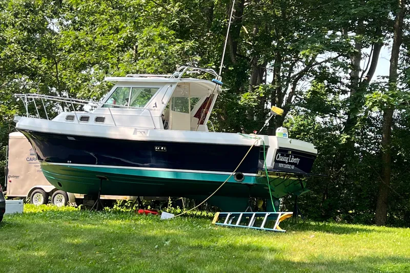 Slide: The Image of 2003 Albin 28 TE Flush Deck boat on grass, surrounded by trees. - 3