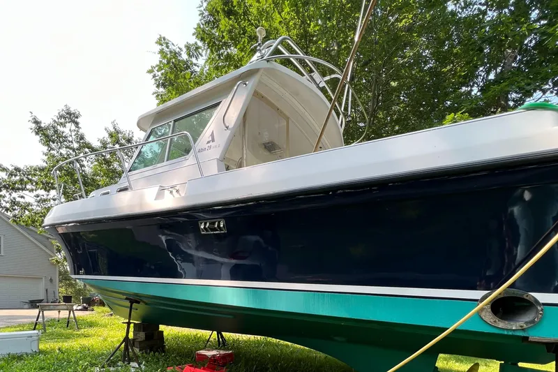 Slide: The Image of 2003 Albin 28 TE Flush Deck boat on land, surrounded by trees. - 4