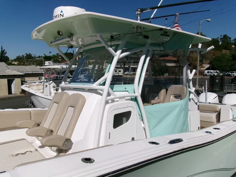 Slide: The Image of 2018 Sea Fox 328 Commander boat with seating and canopy, docked outdoors. - 17