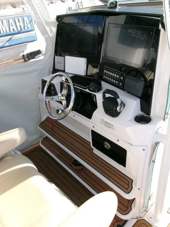 Slide: The Image of 2018 Sea Fox 328 Commander boat dashboard with steering wheel and navigation controls. - 20