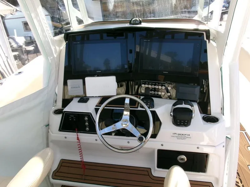 Slide: The Image of 2018 Sea Fox 328 Commander helm with dual screens and modern controls. - 21