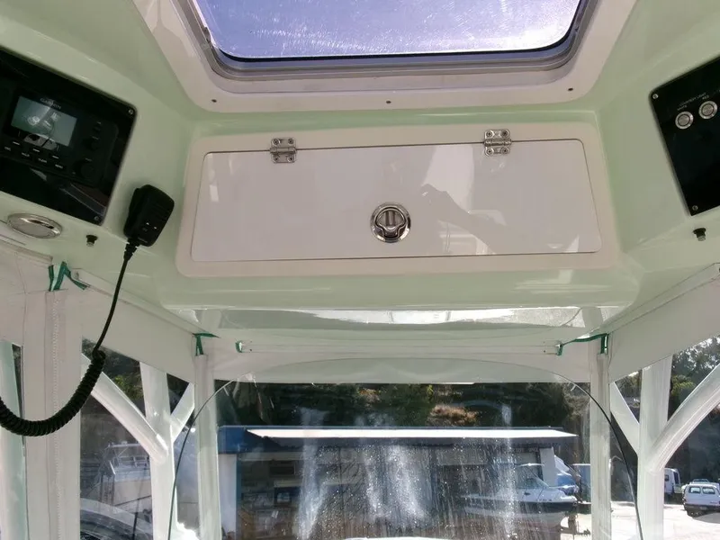 Slide: The Image of Interior view of 2018 Sea Fox 328 Commander boat with control panel and storage compartment. - 22