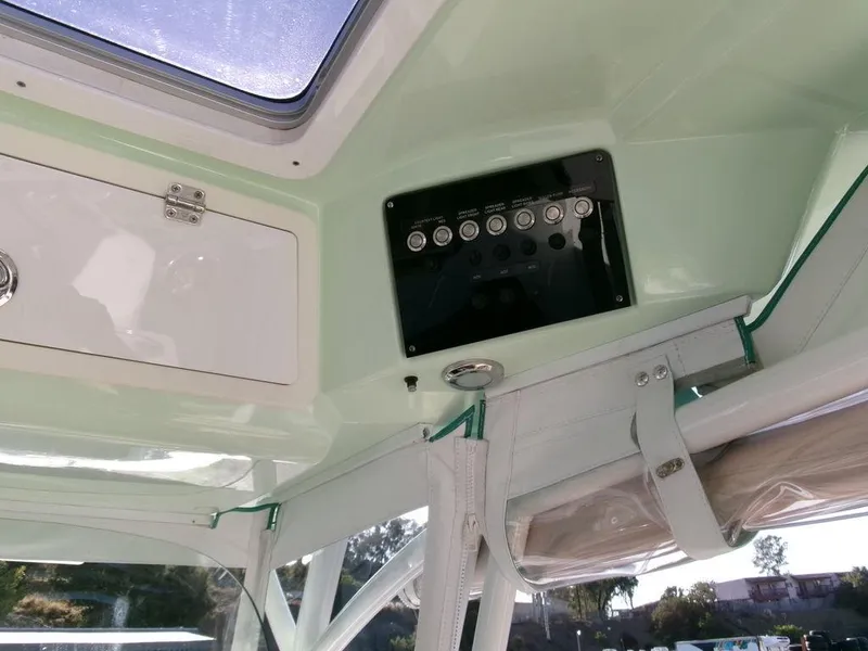 Slide: The Image of Interior view of 2018 Sea Fox 328 Commander boat, featuring control panel and storage compartment. - 24