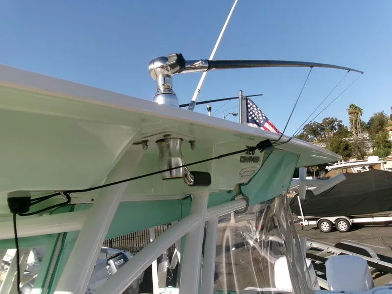 Slide: The Image of 2018 Sea Fox 328 Commander boat with fishing rod holder and American flag in marina. - 27