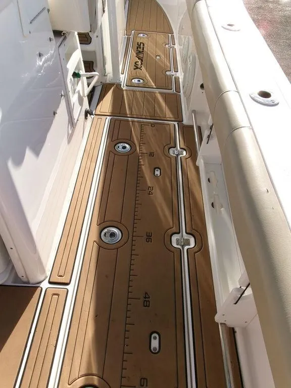 Slide: The Image of 2018 Sea Fox 328 Commander boat deck with teak flooring and measurement markings. - 38