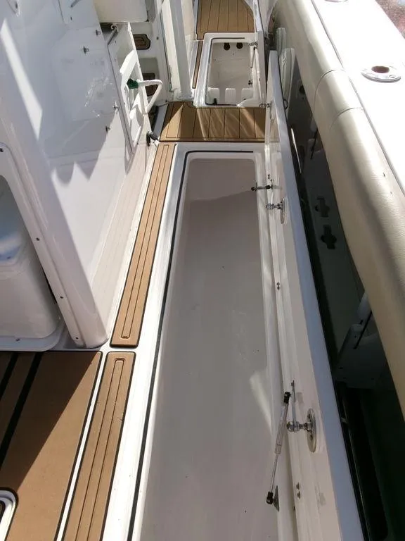 Slide: The Image of 2018 Sea Fox 328 Commander boat deck with storage compartments open. - 39