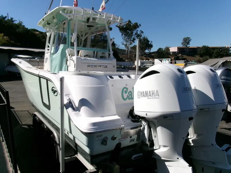 Slide: The Image of 2018 Sea Fox 328 Commander boat with twin Yamaha engines, docked outdoors. - 4