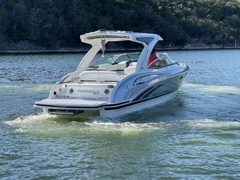 Slide: The Image of 2025 Formula 310 Bowrider cruising on a serene lake, showcasing sleek design and luxury. - 10