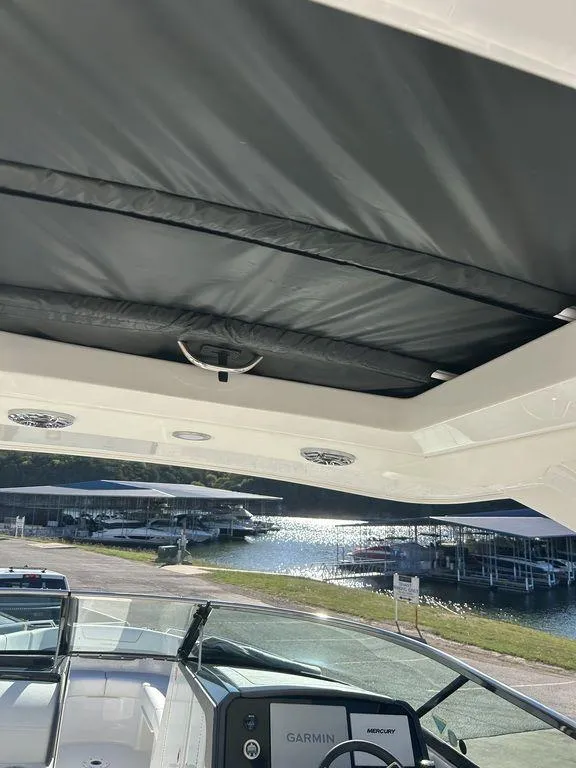 Slide: The Image of 2025 Formula 310 Bowrider boat interior with sunroof and Garmin navigation system. - 19