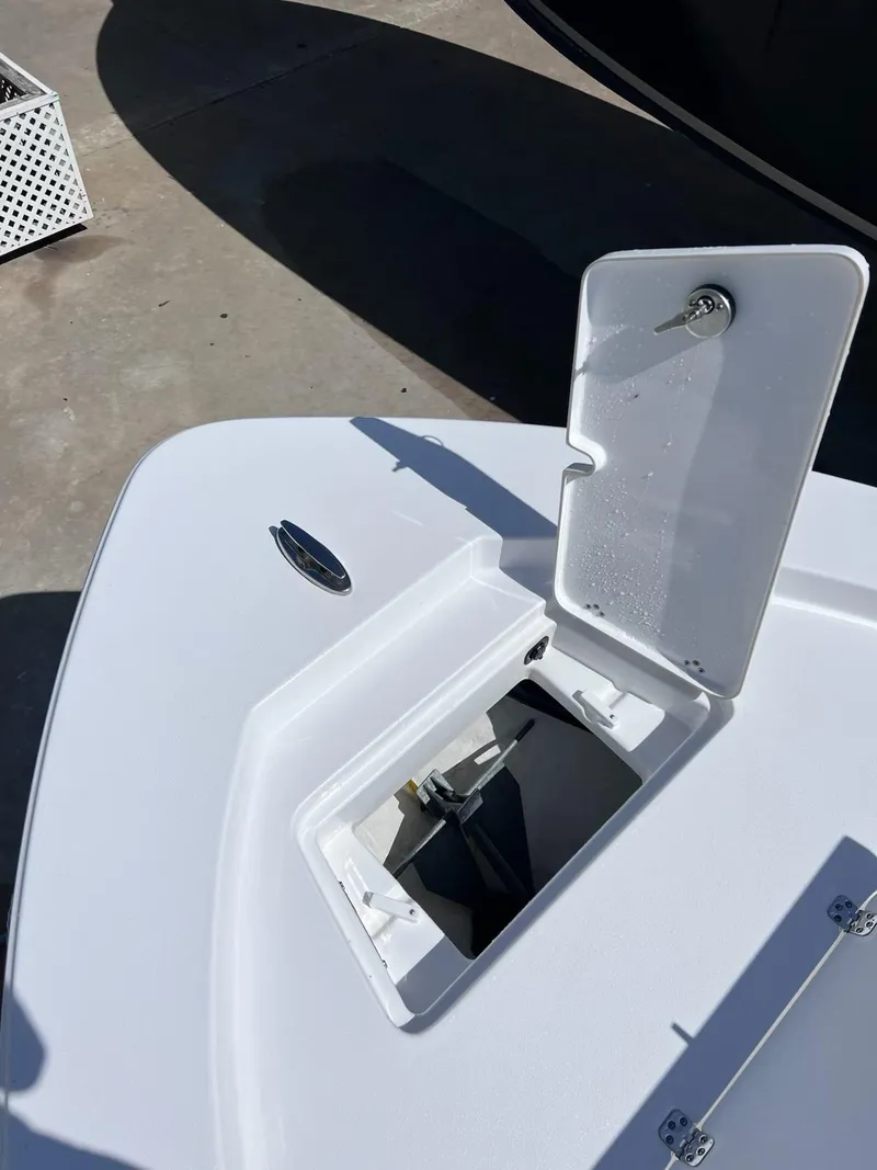 Slide: The Image of 2023 Sportsman Masters 227 Bay Boat anchor compartment open on deck. - 10