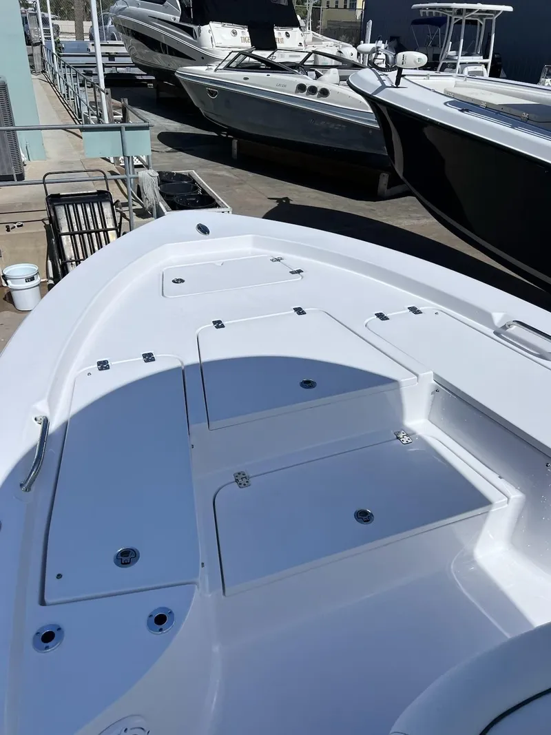 Slide: The Image of 2023 Sportsman Masters 227 Bay Boat with spacious deck and storage compartments. - 13