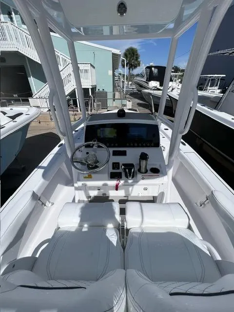 Slide: The Image of 2023 Sportsman Masters 227 Bay Boat interior with modern dashboard and seating. - 15