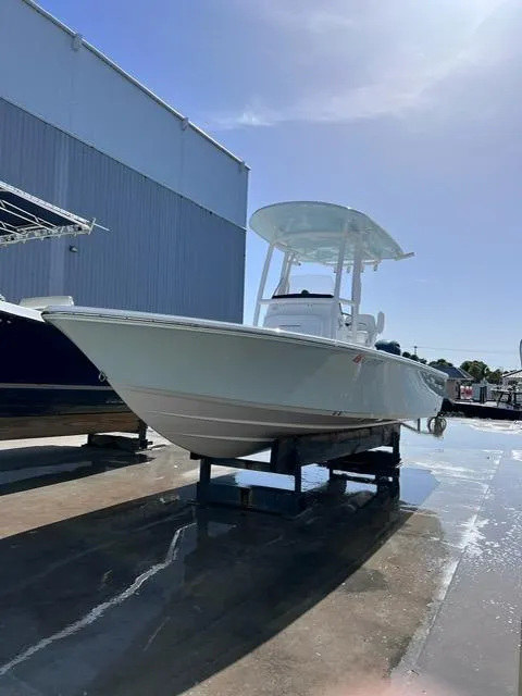 Slide: The Image of 2023 Sportsman Masters 227 Bay Boat on display in a marina. - 16