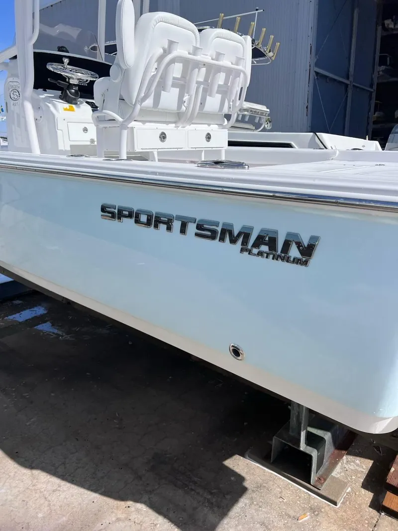Slide: The Image of 2023 Sportsman Masters 227 Bay Boat, white hull, docked outdoors. - 21