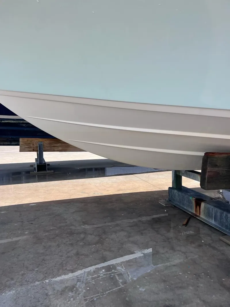 Slide: The Image of 2023 Sportsman Masters 227 Bay Boat hull on display. - 23