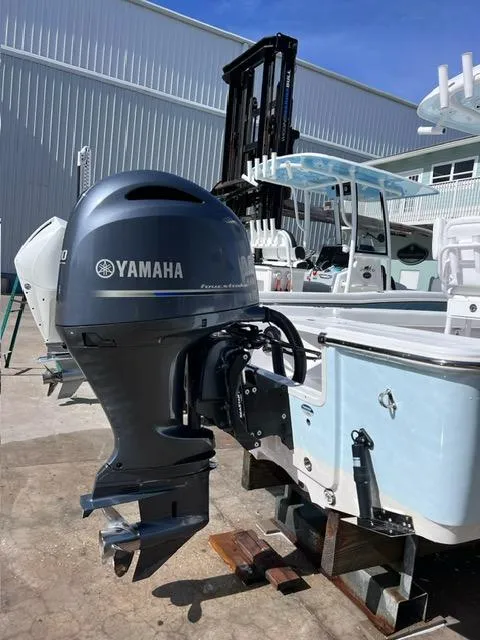 Slide: The Image of 2023 Sportsman Masters 227 Bay Boat with Yamaha outboard motor in marina setting. - 3