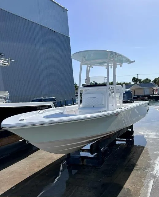Slide: The Image of 2023 Sportsman Masters 227 Bay Boat docked under clear sky. - 5