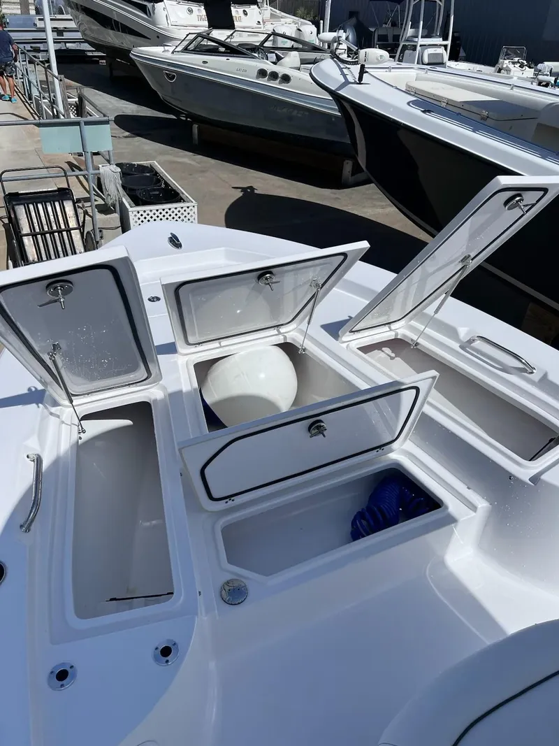 Slide: The Image of 2023 Sportsman Masters 227 Bay Boat with open storage compartments. - 9